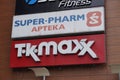 Closeup shot of Super Pharm and TK Maxx logos on the Galeria Malta shopping mall building