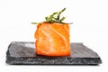 Closeup shot of a sushi roll on a black stone plate Royalty Free Stock Photo