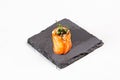 Closeup shot of a sushi roll on a black stone plate Royalty Free Stock Photo
