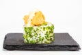 Closeup shot of a sushi roll on a black stone plate Royalty Free Stock Photo