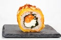 Closeup shot of a sushi roll on a black stone plate Royalty Free Stock Photo