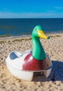 Closeup shot of a swan pedal boat on the sand of the beach with the blue sea in the background Royalty Free Stock Photo