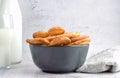 Closeup shot of sweet French pastry, palm leaf shaped, served in a bowl and a glass of milk Royalty Free Stock Photo