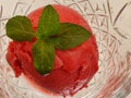 Closeup shot of sweet strawberry ice cream with fresh mint leaves Royalty Free Stock Photo
