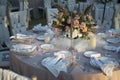 Closeup shot of a table setting with white plates, candles and flowers for a wedding reception Royalty Free Stock Photo