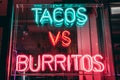 Closeup shot of a tacos vs burritos neon sign