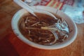 Closeup shot of a Taiwanese Oyster vermicelli soup with meat in a white bowl