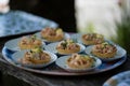 Closeup shot of the tart shells with majo and shrimps decorated on a round plate