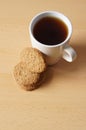 Closeup shot of the tasty cookies with a cup of coffee on a wooden surface Royalty Free Stock Photo