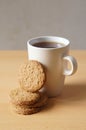 Closeup shot of the tasty cookies with a cup of coffee on a wooden surface Royalty Free Stock Photo