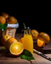 Closeup shot of tasty ripe oranges and fresh orange juice in a glass bottle on a wooden table Royalty Free Stock Photo