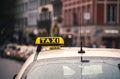 Closeup shot of a taxi sign on a car during a rainy day Royalty Free Stock Photo