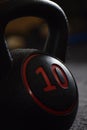 Closeup shot of a ten kilograms dumbbell on a blurred background