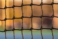 Closeup shot of a tennis court net in the late afternoon Royalty Free Stock Photo