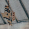 Closeup shot of a Texas license plate carved into a wind chime Royalty Free Stock Photo