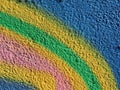 Closeup shot of a textured wall painted by multiple colors in a rainbow shape Royalty Free Stock Photo