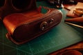 Closeup shot of thick leather camera case and tools for leathercraft on the table Royalty Free Stock Photo