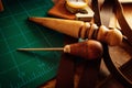 Closeup shot of thick leather sheets and tools for leathercraft on the table