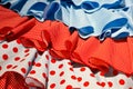 Closeup shot of three different multicolored Spanish flamenco dress fabrics
