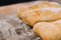 Closeup shot of three freshly baked loaves of artisanal bread on a table cloth Royalty Free Stock Photo