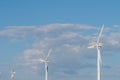 Closeup shot of three white wind energy turbines on a sunny day Royalty Free Stock Photo