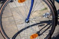 Closeup shot of the tire of a blue bicycle on the pavement captured on a sunny day Royalty Free Stock Photo