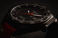 Closeup shot of a Tissot watch under dynamic lighting - concept of fashion