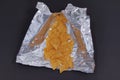 Closeup shot of tortilla chip in an opened package isolated on a black background