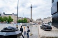 Closeup shot of a traditional black cab driving through the most famous landmarks in London