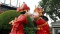 Closeup shot of traditional statues in human form kissing in China Folk Village park in Shenzhen