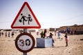 Closeup shot of a traffic sign with a group of people in a blurred background Royalty Free Stock Photo