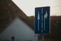 Closeup shot of a traffic sign with two arrows in different directions on a blue backgroundÃ¢â¬Â¤ Royalty Free Stock Photo