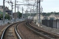 Closeup shot of train railings in the middle of the town surrounded by trees