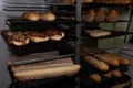 Closeup shot of trays with freshly baked bread, croissants, muffins in a pastry shop