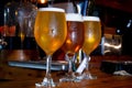 Closeup shot of tree glass of beer on wooden table Royalty Free Stock Photo