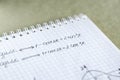 Closeup shot of trigonometric formulas written on a notebook paper