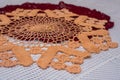 Closeup shot of two crochet doilies, one red and one cream-colored, on a white surface Royalty Free Stock Photo