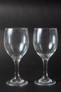 Closeup shot of two empty wine glasses on black background with copy space for text Royalty Free Stock Photo