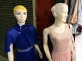 Closeup shot of two female mannequins in the electric-blue and pink dresses