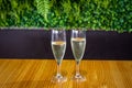 Closeup shot of two glasses of prosecco placed on a wooden table