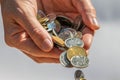 Closeup shot of two hands full of Canadian cash coins and dropping them Royalty Free Stock Photo