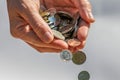 Closeup shot of two hands full of Canadian cash coins and dropping them Royalty Free Stock Photo