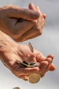 Closeup shot of two hands full of Canadian cash coins and dropping them Royalty Free Stock Photo
