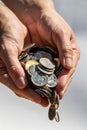 Closeup shot of two hands full of Canadian cash coins and dropping them Royalty Free Stock Photo