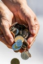 Closeup shot of two hands full of Canadian cash coins and dropping them Royalty Free Stock Photo