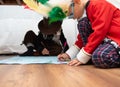 Closeup shot of two kids drawing together sitting on the floor Royalty Free Stock Photo