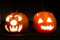 Closeup shot of two lighted Halloween jack o' lanterns