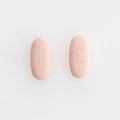 Closeup shot of two oval medical pills isolated on a white background Royalty Free Stock Photo