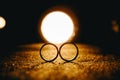 Closeup shot of two rings under a romantic candlelight