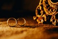 Closeup shot of two rings under a romantic candlelight